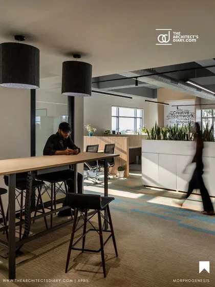 A high-top collaborative table provides an alternative workspace at the Adani office. These informal zones encourage spontaneous interaction and teamwork, supporting a dynamic and agile work culture.