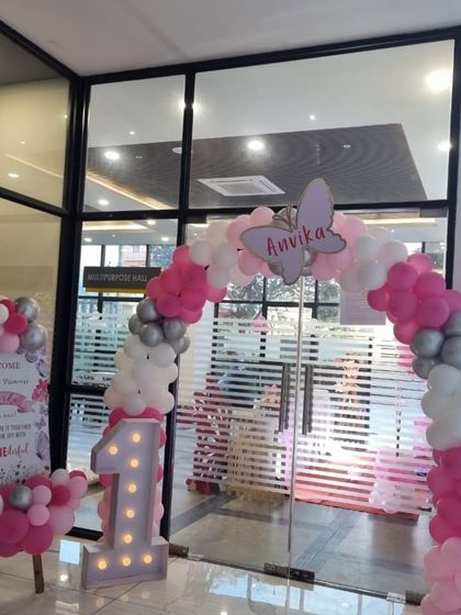 The personalized welcome sign and entrance decor for the butterfly-themed first birthday party.