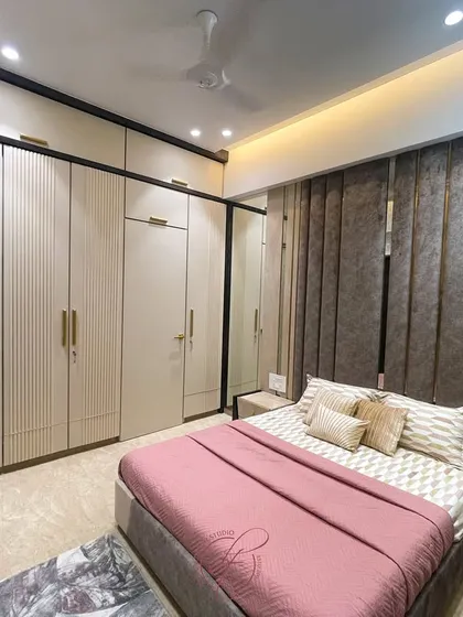 This angle highlights the seamless integration of the wardrobes and the bed, creating a cohesive and well-designed space. The neutral color palette is both timeless and calming.