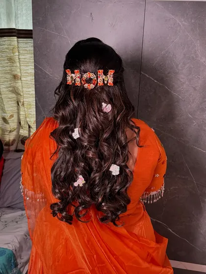 A detailed shot of the custom 'MOM' hair accessory, a personal touch that made her baby shower hairstyle extra special.