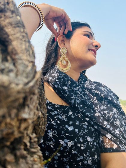 A customer wearing our heavy-look pearl chandbalis and matching maang tika.