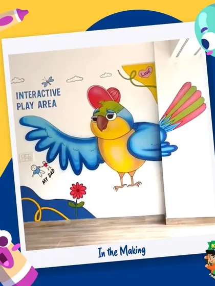 A shot of the large, colorful parrot mural in our interactive play area, showcasing the vibrant and engaging artwork throughout the facility.