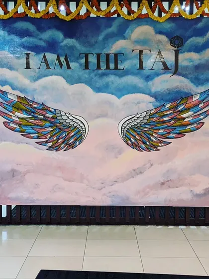 We design interactive murals that engage visitors, like this "I am the Taj" wings piece at Taj Bangalore. It serves as a popular photo booth and selfie spot, adding value to the commercial space.