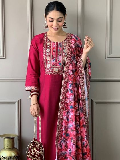 A gorgeous rani pink viscose chanderi kurta with a stunning floral printed dupatta. The heavy embroidery on the neckline makes it perfect for a festive occasion.