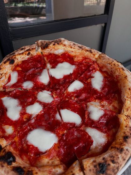 A simple, classic mozzarella pizza, perfectly baked with a beautiful char. Sometimes less is more.