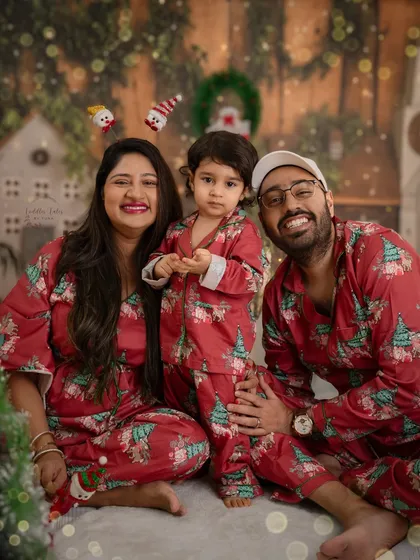 A happy family in matching Christmas pajamas. These cozy, candid moments are what make holiday photoshoots so special and memorable.