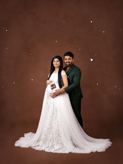 A stylish couple's portrait. The contrast of the sparkling white gown against his dark green suit creates a modern and sophisticated look.