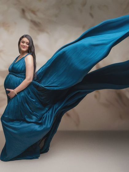 Capturing the essence of expectancy with the elegant flow of azure silk. This stunning shot is a blend of artistic vision and technical precision, highlighting the grace of motherhood.