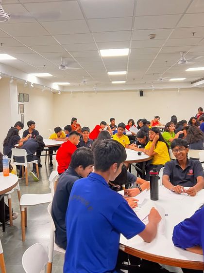 Students engaged in a collaborative writing activity at our Prometheus School workshop. We make learning fun, interactive, and team-oriented.