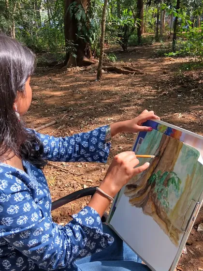 We believe art isn't confined to the studio. Here is a student during an outdoor plain-air painting session, capturing the beauty of nature firsthand to create a realistic landscape drawing.