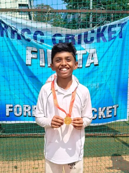 Celebrating individual brilliance at the grassroots level. A young player proudly displays his Player of the Match medal at the RRCC Cup U-10 tournament, a crucial part of building confidence from a young age.