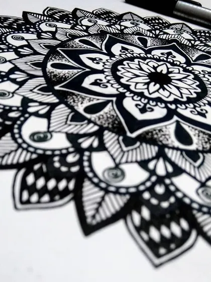 An angled shot of the floral mandala, highlighting the shading and dot work that gives the petals a three-dimensional feel. These small details make a big difference in the final artwork.
