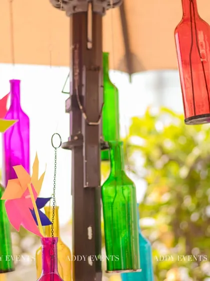 A close-up of the colorful hanging bottles and pinwheels, part of the fun and quirky decor for the Haldi.