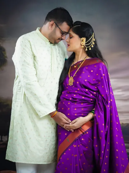 We love capturing the quiet, intimate moments between partners. This traditional maternity portrait, featuring a beautiful purple saree and ethnic jewellery, highlights the deep connection and shared anticipation of welcoming a new life.