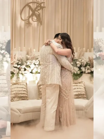 A heartfelt hug after the proposal, with the couple framed by the beautiful white floral decor.