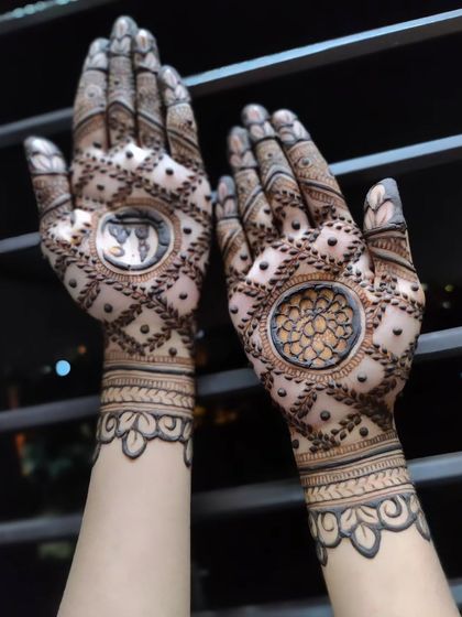 A beautiful Eid design with a mix of check patterns and a central figure. The leaf-style borders on the wrist give it a unique touch.