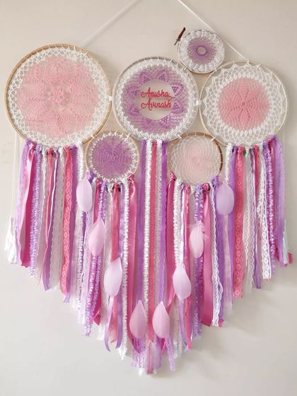 A mesmerizing pink and purple cluster dreamcatcher, personalized with the names 'Anisha' and 'Avnish'. This handcrafted statement piece is perfect for capturing hearts and dreams.