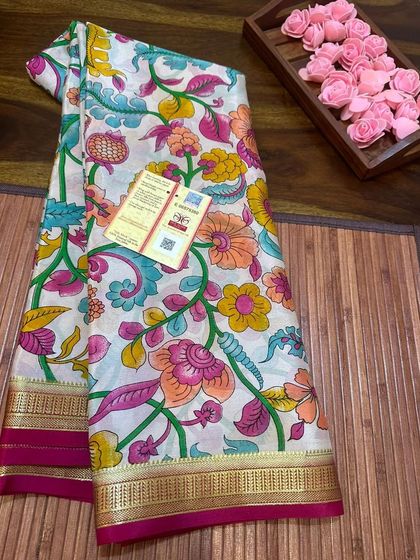 A Silk Mark certified printed Kalamkari Mysore silk saree. This piece features a vibrant floral print on a white base with a contrasting pink border.