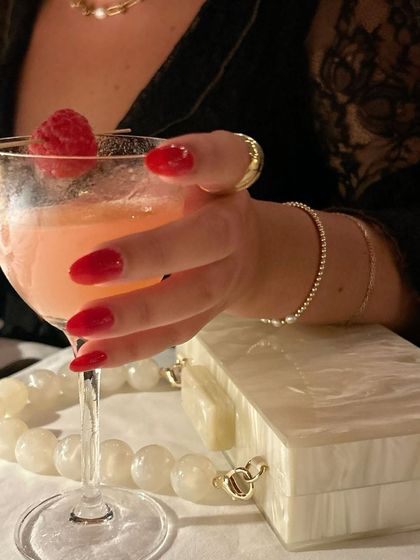 A fancy cocktail hour is always better with a fresh manicure. These classic red nails are perfect for a night out.