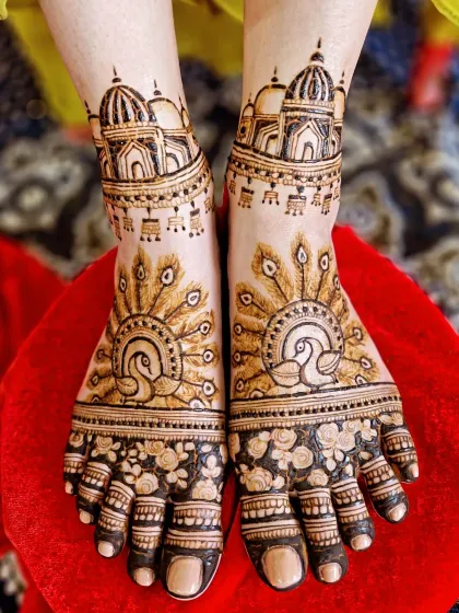 A top-down view of the stunning peacock and temple feet design, showing the intricate details on the toes and ankles.