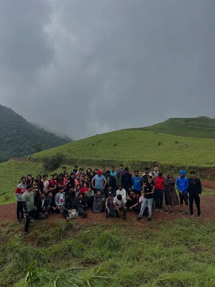 A large group photo on the green slopes of Kodachadri.