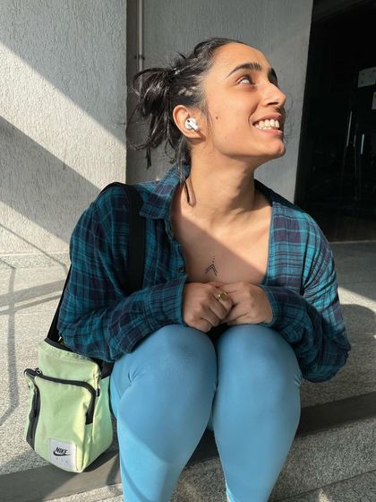 Looking up with a smile, enjoying the simple pleasure of a sunny day.