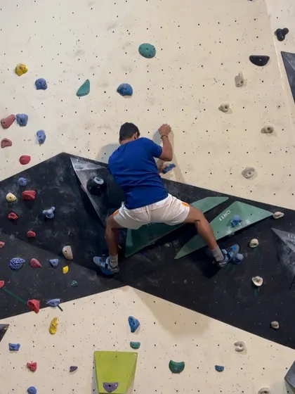 A climber navigates a challenging section of our wall, focusing on technique and balance. This is what it's all about: solving puzzles with your body and having a great time doing it.