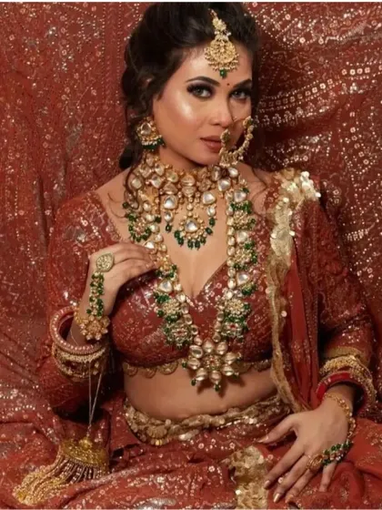 This sequined red lehenga creates a stunning, fiery look, especially when paired with a heavy Kundan and emerald jewellery set.