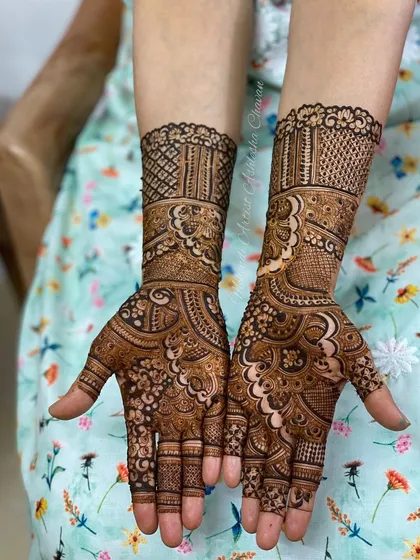 A beautiful mehendi design with a mix of traditional and modern elements. The patterns are intricate and create a rich, textured look.