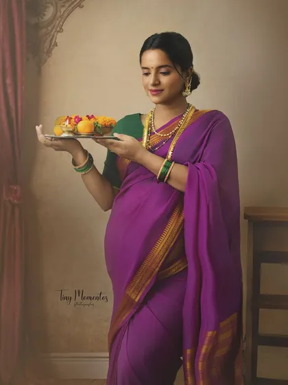 Holding a traditional platter of flowers, this image is full of grace and celebrates the auspicious nature of new life.