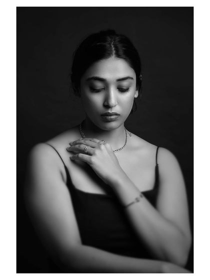 A quiet, introspective moment captured in black and white. The soft lighting and closed eyes convey a sense of peace and vulnerability, making for a deeply personal portrait.