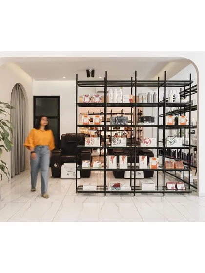 Another view of the versatile shelving unit, which acts as a porous boundary in the open-plan layout.