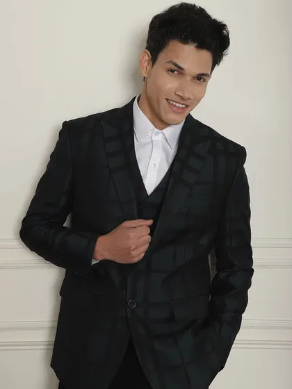 When the occasion is formal, wear a tailored suit. This black checkered three-piece suit is a modern classic.