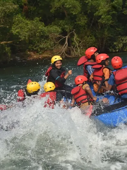Laughter and splashes fill the air as a team enjoys the bumpy ride through the rapids. It's not just about adrenaline; it's about having fun.