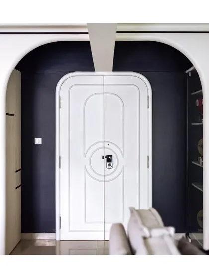 The main door, with its custom moulding and arched frame, is a work of art in itself. It's a perfect introduction to the European-inspired elegance that lies within.