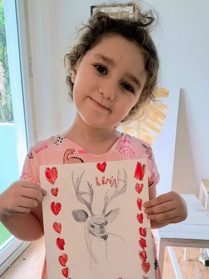 A duplicate image of a younger artist's take on the deer sketch, adding a personal touch with a border of red hearts.