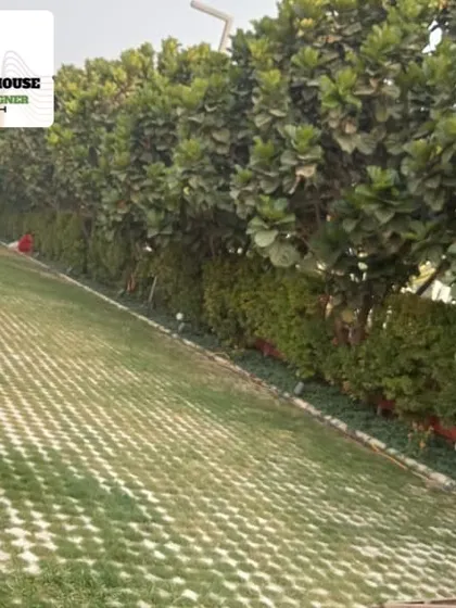 A sloped lawn created with turf-reinforcing pavers, allowing grass to grow through a structural grid for stability and erosion control.