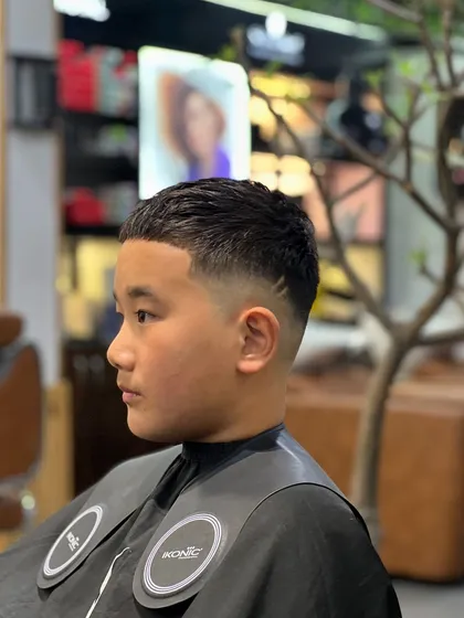 A classic low fade haircut. This timeless style is perfect for any occasion and can be customized to suit your preference.