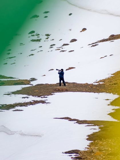 A shot of me in action, capturing the vast snowy landscape with my telephoto lens.