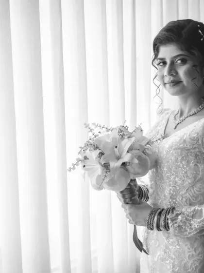 A timeless black and white bridal portrait. This classic style emphasizes the bride's expression and the beautiful texture of her dress.