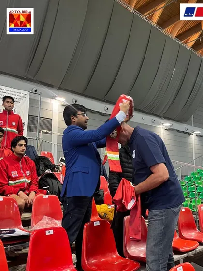 A gesture of respect and friendship. Mr. Anuj Gupta places a Sudeva scarf on an MTU Cup official, symbolizing the strong bond between our clubs.