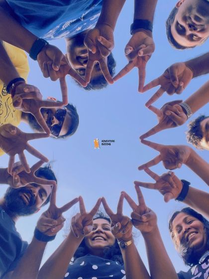 A creative group photo forming a star with their hands.