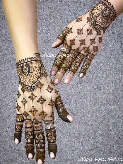 A unique design with a 'jaali' or net pattern covering the entire back of the hand, accented with a bold cuff.