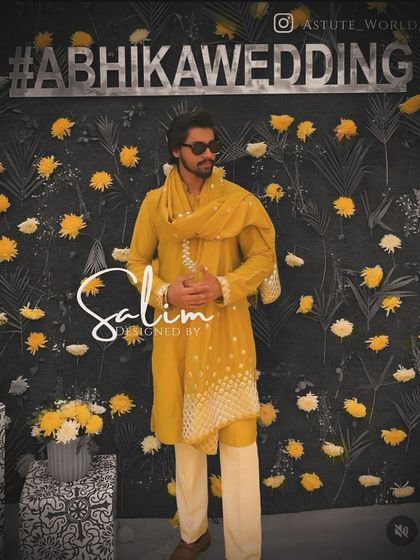 A client at a wedding event, wearing a mustard yellow kurta with a matching stole that has delicate mirror work. A stylish and comfortable option for a pre-wedding function.