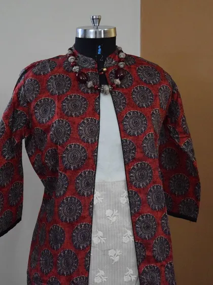 I love layering, and this poly-silk printed jacket paired with a simple Kota Doriya kurta is a perfect example of chic Indo-Western styling. It's a versatile combination that can be dressed up or down for any occasion.