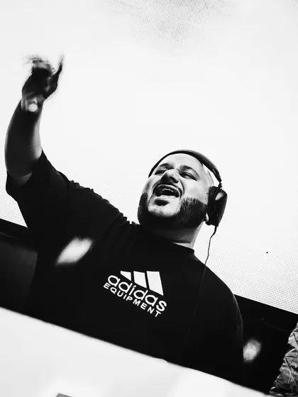 A black and white action shot of me, hand in the air, feeling the music at a gig in Jaipur. This is pure passion.
