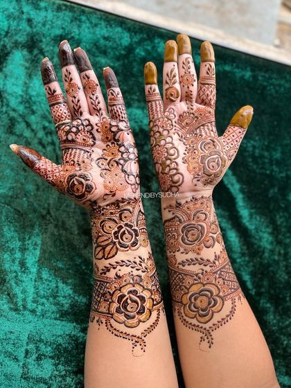 This design is a gorgeous fusion of styles, with bold, dark-filled roses on one arm and more delicate, shaded florals on the other, creating a unique and asymmetrical look.