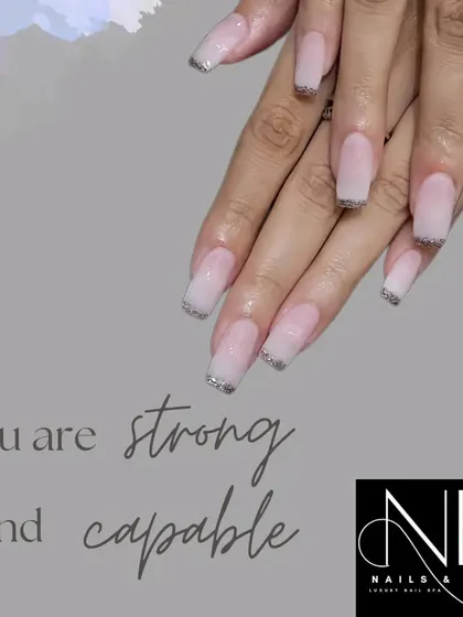This is another example of our glitter French tip design. We used a subtle silver glitter on the tips of these long, square-shaped acrylic extensions for a clean yet sparkly finish.