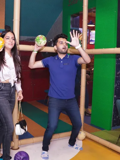 Fun isn't just for kids. Here, parents are seen enjoying a friendly game in one of our interactive play zones during a birthday party.