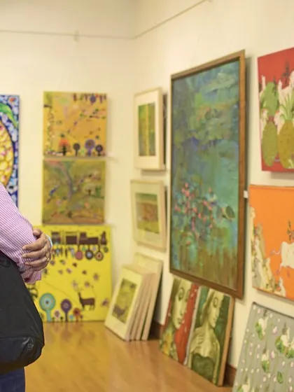 An art enthusiast immerses herself in the collection during our Art Annual 2016. We foster an environment where visitors can connect personally with the art, spending time to appreciate the details and stories behind each piece.